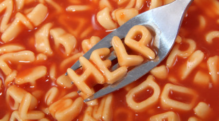Spaghetti letter spelling the word help with the letters held up on a fork.