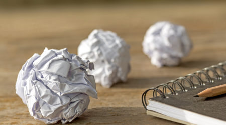 ball paper with notebook on wooden table.