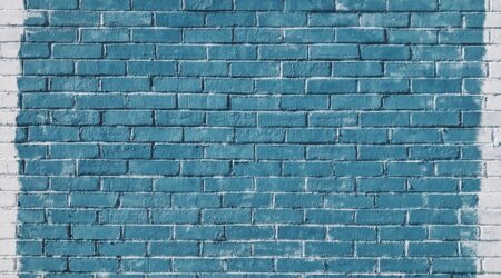 Image of a brick wall painted in blue
