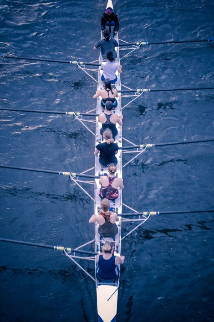 Arial photograph of nine people rowing in a boat